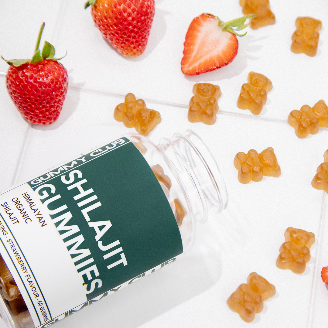 Shilajit Gummies packaging with gummy bears and strawberries on a white background